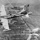 A Boeing KB-50J refuels a trio of North American F-100 Super Sabres. Note the wingtip fuel tanks and jet engines on this KB-50J, as well as the downward flight angle as the tanker “toboggans” to keep pace with the faster fighters. (US Air Force)
